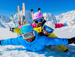  A family of skiers plays in the snow. 