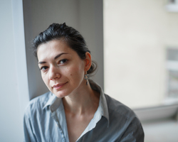 A young woman looks up into the camera.