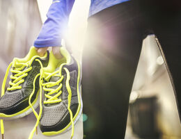 Running shoes in a woman’s hand.