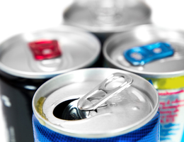 Close-up of the tops of four energy drink cans