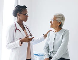 A doctor talking to her female patient.