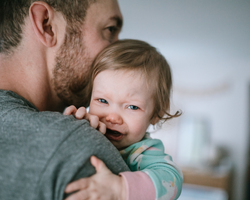  A man holds a smiling baby