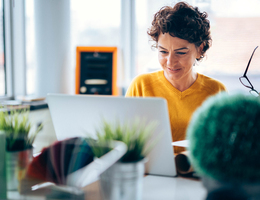 A woman uses a laptop in her office