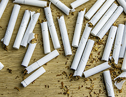 A pile of broken cigarettes on a table. 