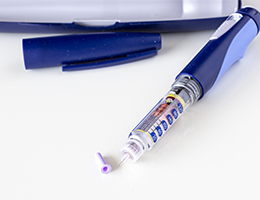 An EpiPen lies on a table.